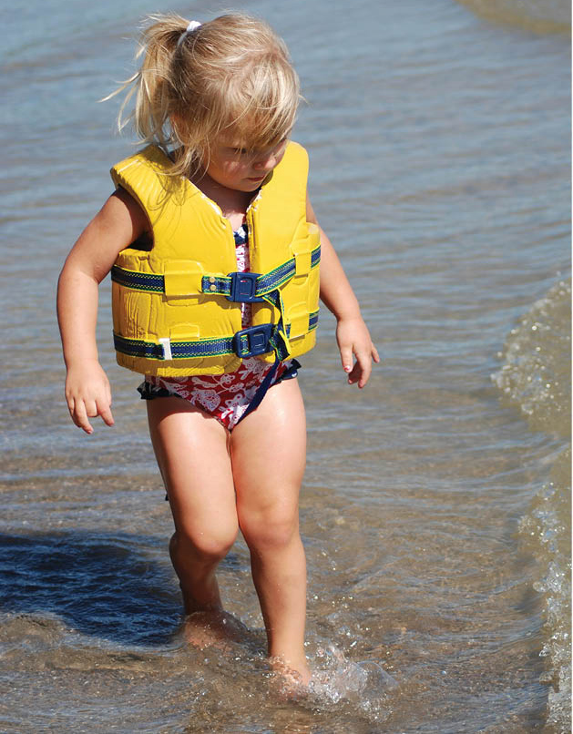 Little Girl wearing a yellow lifejacket.