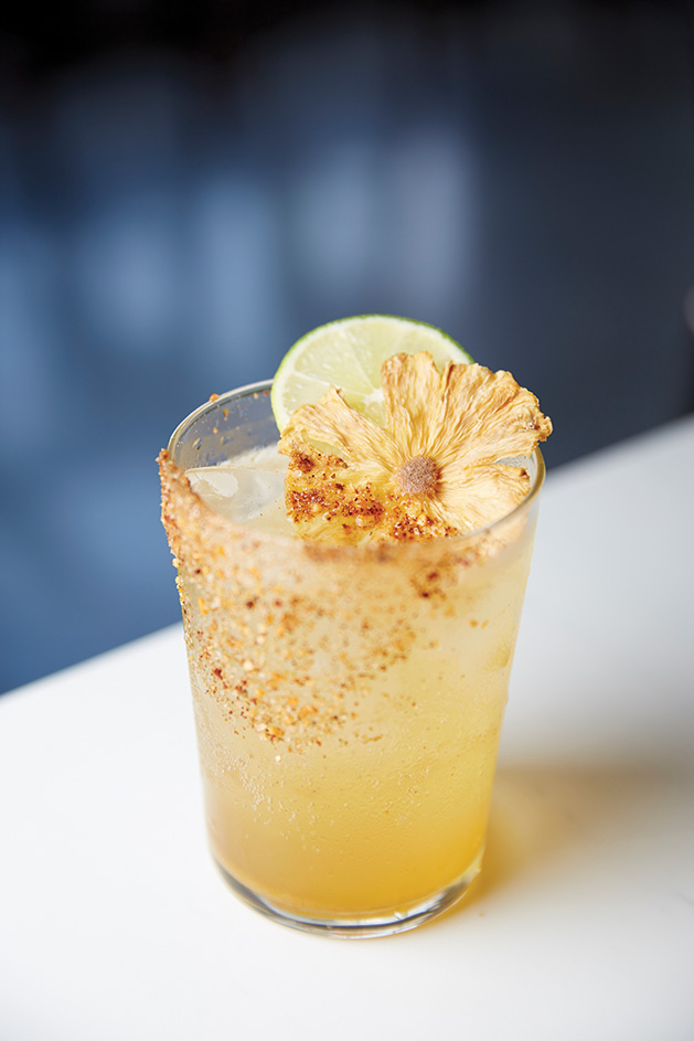 Cocktail Garnished with Lime and Dried Flower