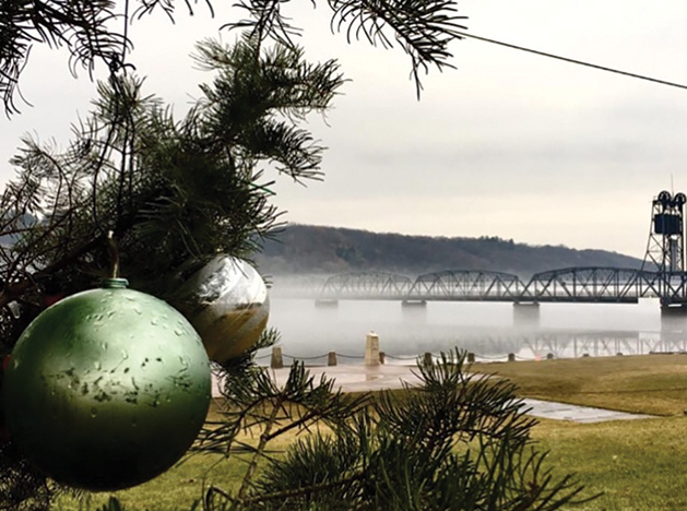 An ornamented tree sits in the foreground in front of the Stillwater Life Bridge