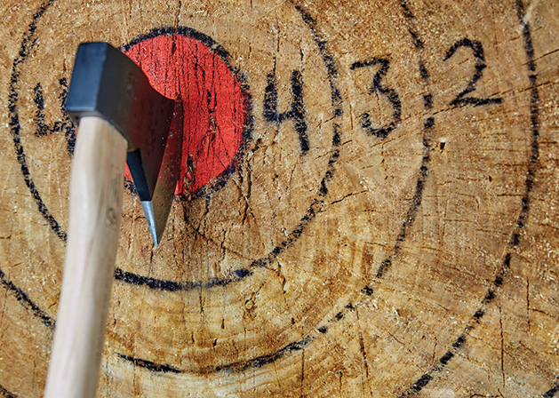 An axe lodged in a target at The Lumberjack Bar