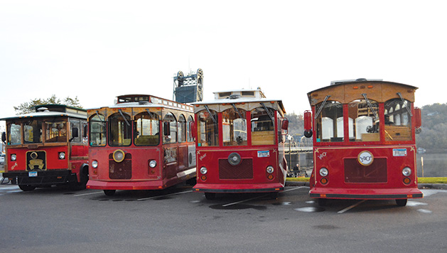 Four trolleys from Stillwater Trolley await riders before a tour of the city.