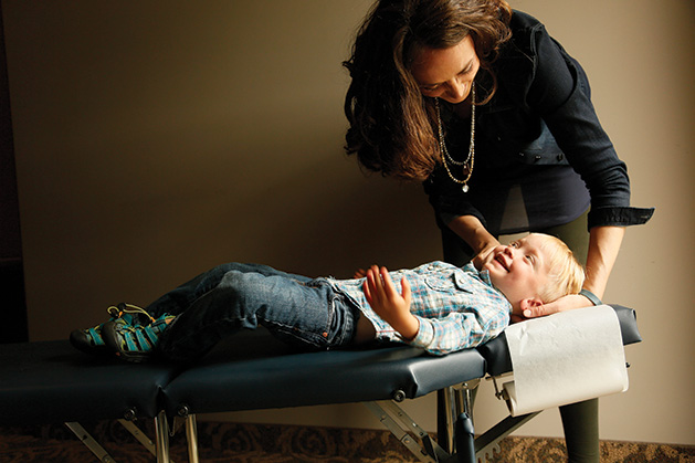 A chiropractor from Croixview Family Chiropractic works on a patient.