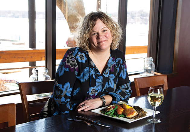 Pier 500 assistant general manager Katy Rugg enjoys a meal and a glass of white wine.