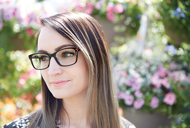 A woman models a pair of statement glasses.