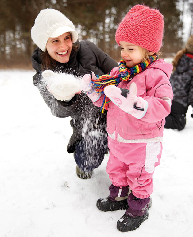 Annie Berthiaume and youngest daughter Frances play in the snow.