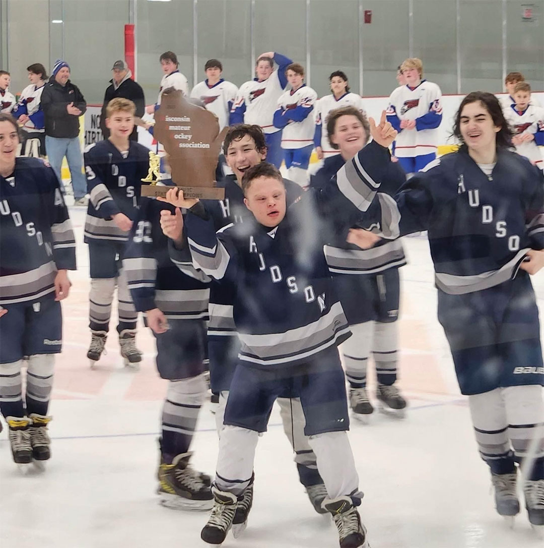 Ian raises a trophy as Hudson Hockey Association’s Bantam C Team celebrates its state championship win.