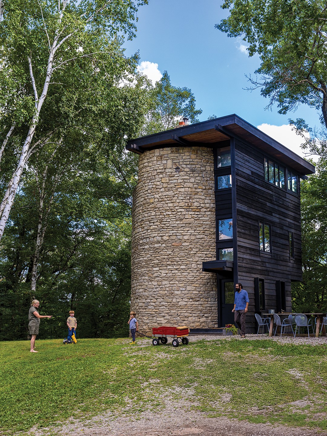 Greg Elsner and Kadie Fredell play with their two sons outside their year-round abode in Taylors Falls.