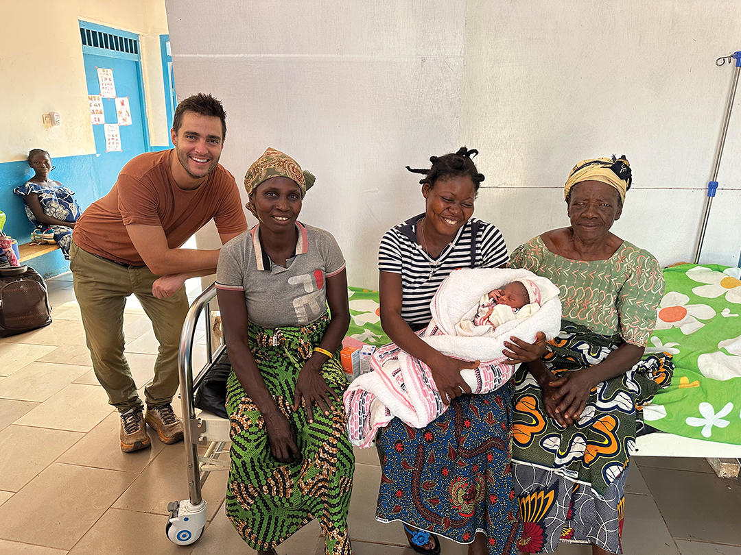Ted Hooley stands with four generations of women from the same family. The newest addition was the first to be born in a clinic.