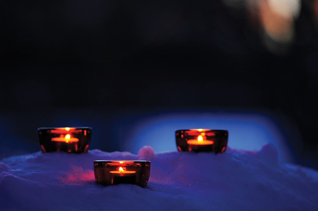 Candles in the winter snow.