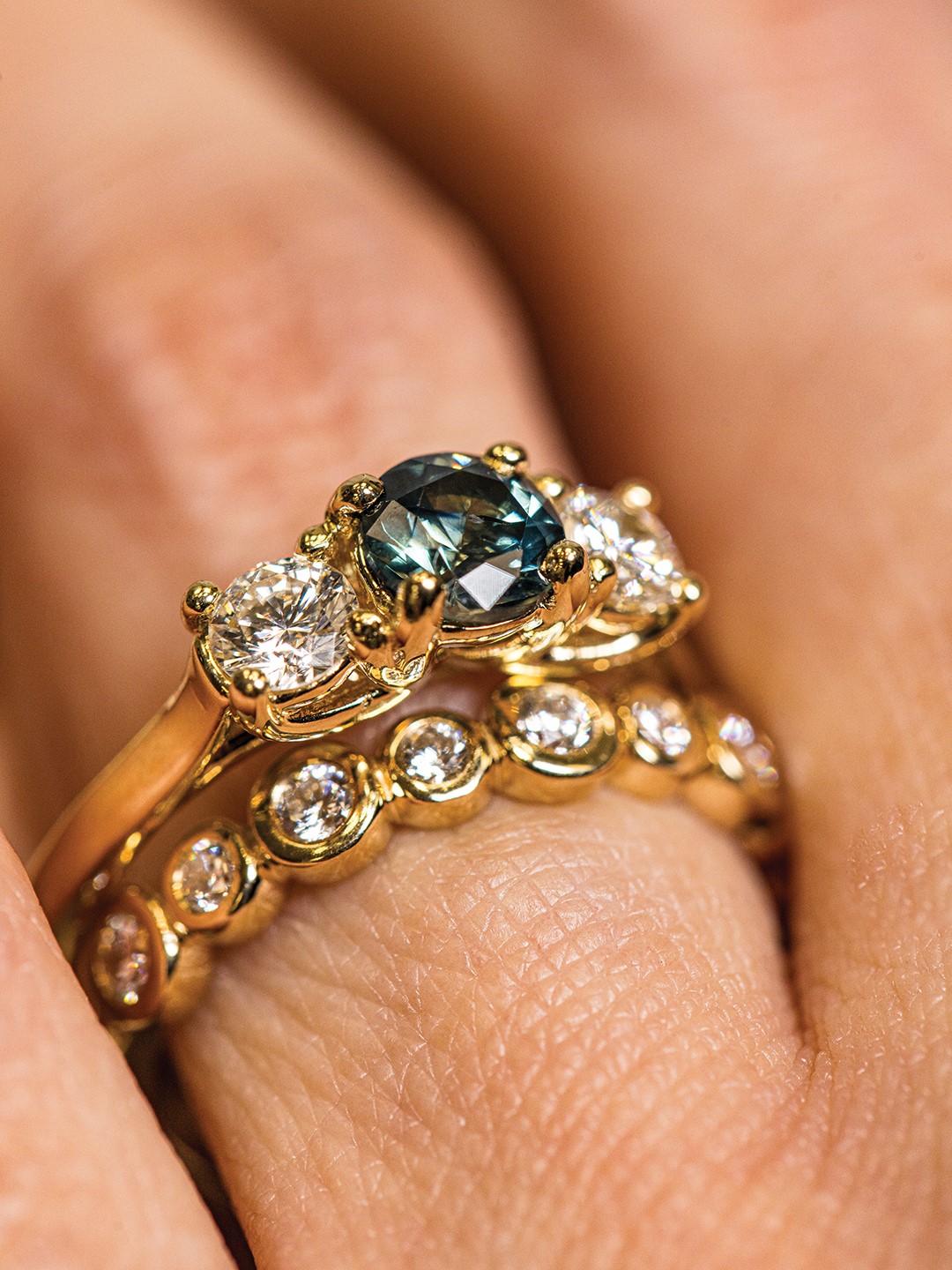 Ethical stone sourcing is important at The Jeweler's Bench, and this engagement ring, featuring a teal blue Montana sapphire with two round, brilliant-cut diamonds, is no exception.