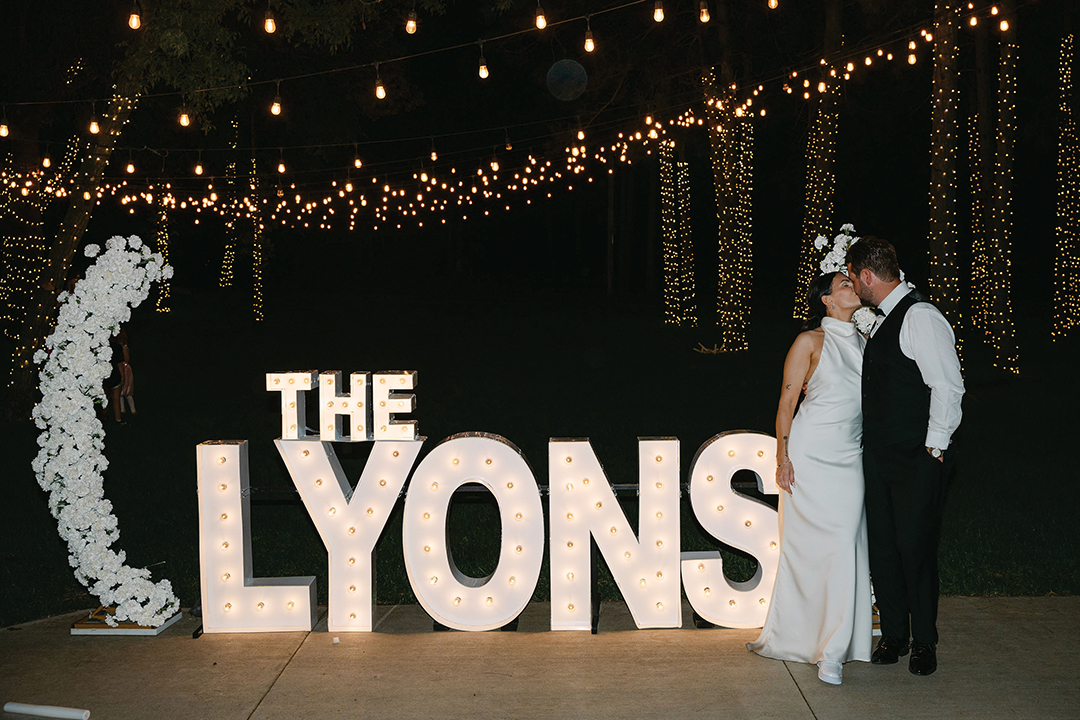 Marquee letters lit up the night at the Lyonses’ reception, pairing beautifully with the venue’s twinkle-light-laden trees.