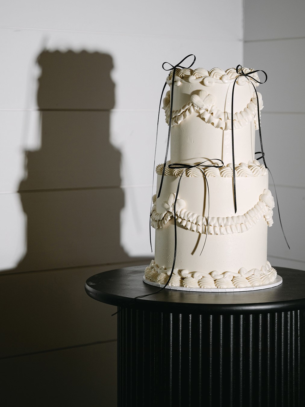 Complete with black bows and detailed piping, the red velvet cutting cake by Hey There Cupcake mirrored the personalized mini cakes that adorned each guest’s place setting. 