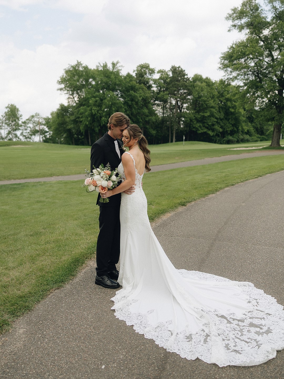 The couple captured portraits on the golf green at The Refuge Golf Club. Morgan Gruber donned a sheath-style gown from Raffiné Bridal; Ryan Gruber selected a suit from Milbern Clothing Co.