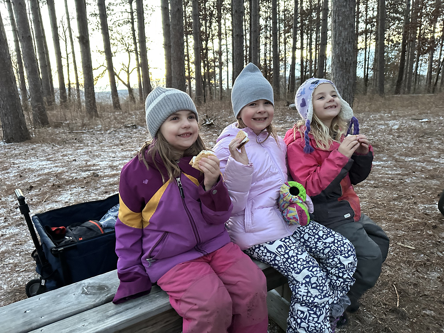 children on bench eating s'mores
