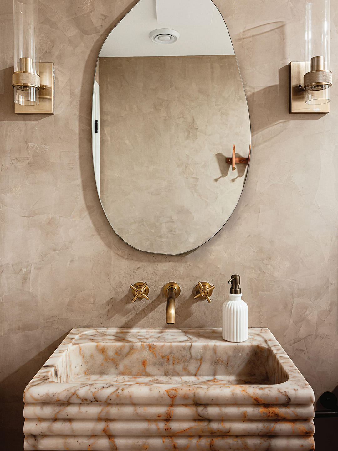 A recent Moonstone Design & Build basement remodel in Lake Elmo featured a stunning bathroom design with a striking marble sink.