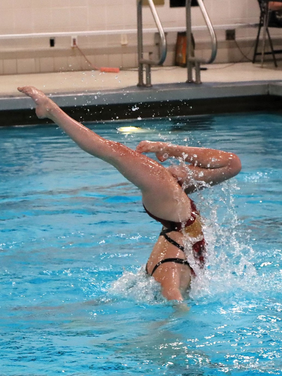 Hailey Schmit is lifted foot first by her teammates.