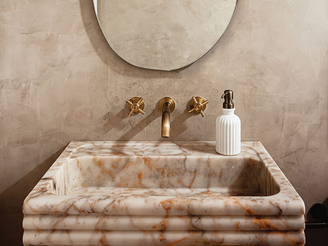 A recent Moonstone Design & Build basement remodel in Lake Elmo featured a stunning bathroom design with a striking marble sink.