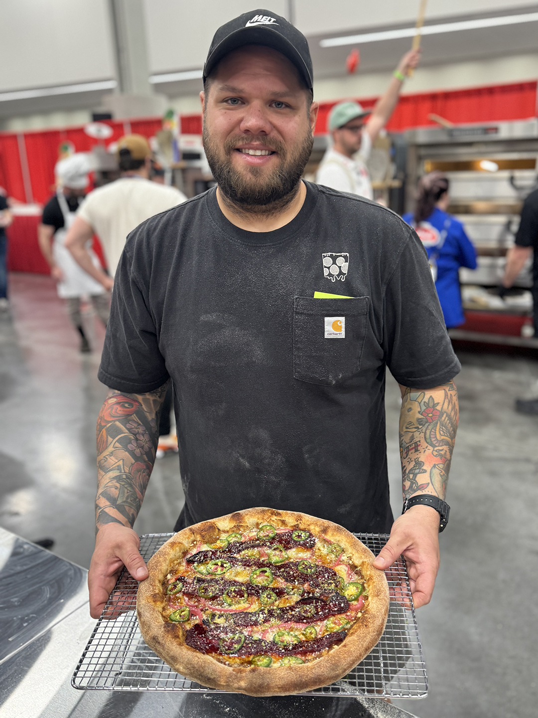 Anthony Gilbert, the owner of Melt Pizza Company, shows off an award-winning pizza.