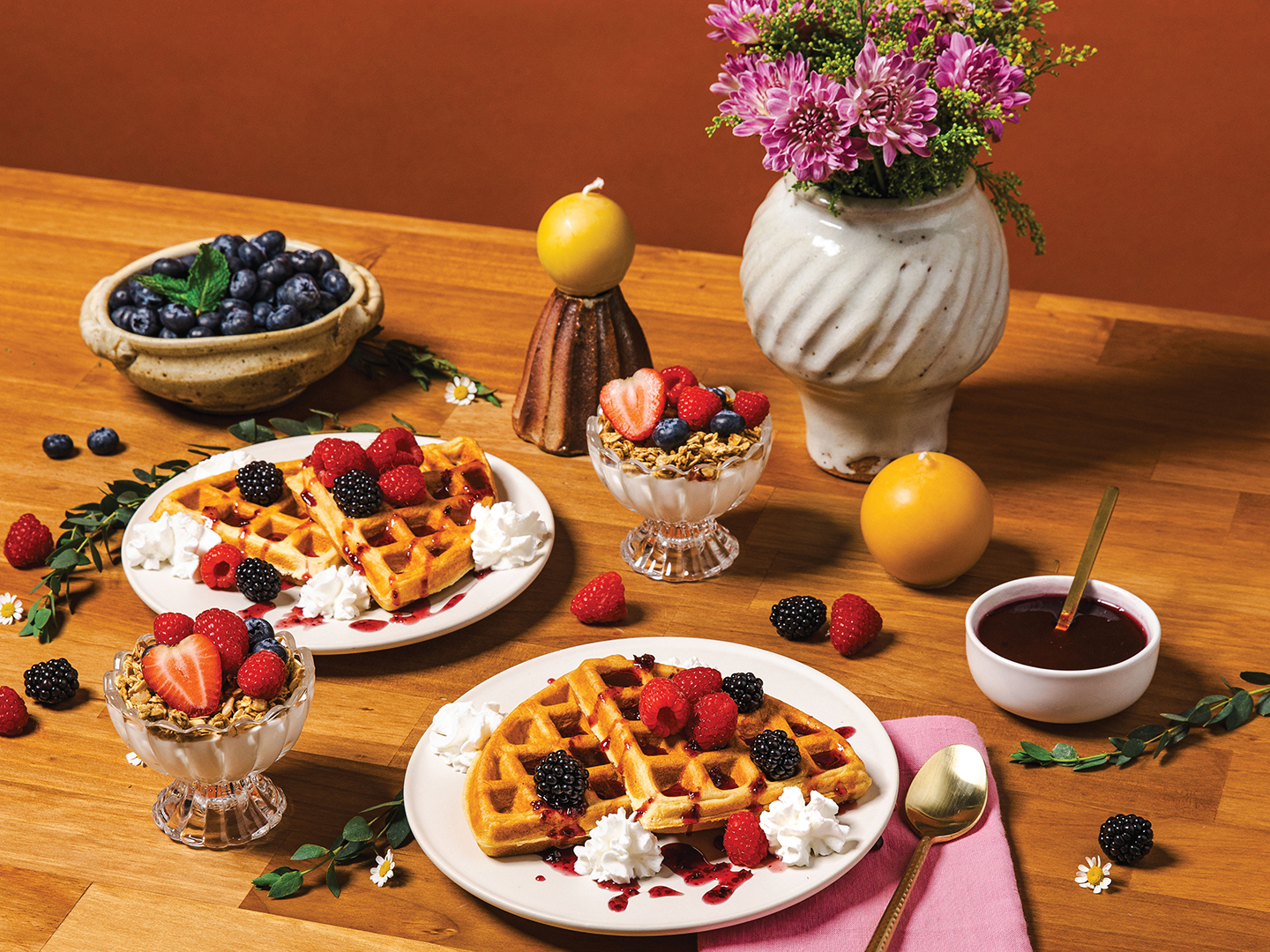 There’s nothing better than a breakfast spread featuring local berries and blooms. Start your day off with mouthwatering waffles topped with berries and whipped cream, or a berry parfait. Bowl and vases by Olivia Jenson, oliviajenson.com; Candles by Hilltop Handmade Goods, @hilltopgoodsmn