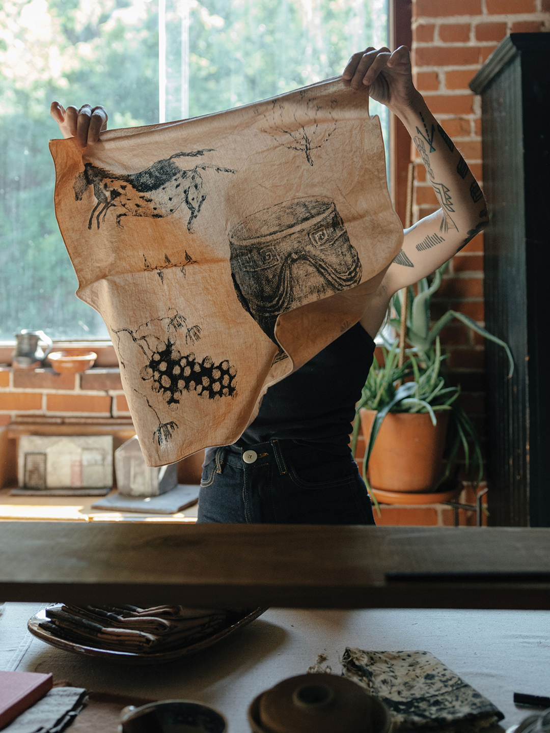 Alexis Stiteler holding up a piece of fabric